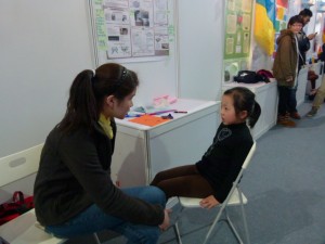 Amy Practices Mandarin With a Young Visitor